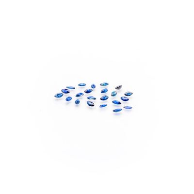 a close up of a group of blue beads on a white surface