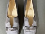 pair of women ' s grey shoes with bows on the toes