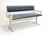 a black and white bench sitting on a white floor