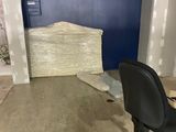 une chaise de bureau noire placée devant une porte bleue