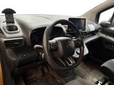 a steering wheel and dashboard of a car with a cell phone in it