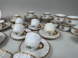 many cups and saucers that are sitting on a table