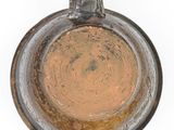 a brown vase that is sitting on a white surface
