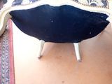 a black and white chair sitting on top of a rug