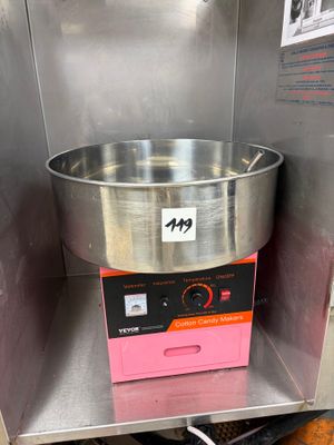 a large metal bowl sitting on top of a machine