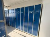 many blue lockers in the hallway of a building