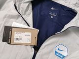 a white jacket with a blue and white logo on it