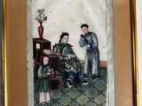 tableau représentant un homme et une femme assis sur une chaise avec un enfant