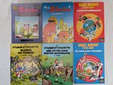 plusieurs livres pour enfants sont alignés sur une surface blanche