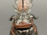 a statue of a dragon with a sword on it ' s head