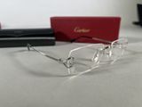 cartier eyeglasses are displayed on a table next to a red box