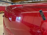 a remote control attached to the back of a red car