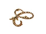an image of a gold bow brooch on a white background