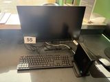 a keyboard and a monitor on a desk with a price tag on it