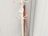 a white coat stand with a coat rack on top of it