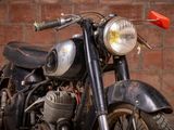 a motorcycle that is parked in front of a brick wall