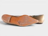 the shoe is made of leather and has a metal toe