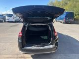 the back of a car with its trunk open in a parking lot