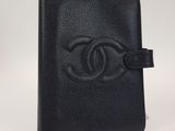 un portefeuille Chanel noir orné du logo Chanel sur le devant