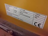 a close up of a sign on a yellow wall
