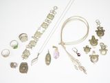 a lot of jewelry that is laying out on the table
