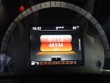 dashboard of a car with a digital clock on the display