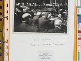 an old photo of a group of people sitting at a table in a meeting room