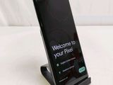 the phone is sitting on a stand with a welcome screen on it