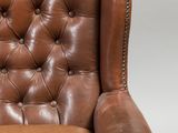an image of a brown leather chair on a white background