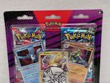 two packs of pokemon trading cards are on a white surface