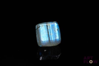 an image of a blue and white stone on a black surface