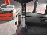 a forklift with a handle on it in a warehouse