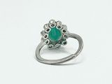 an image of a silver ring with a green stone in the center