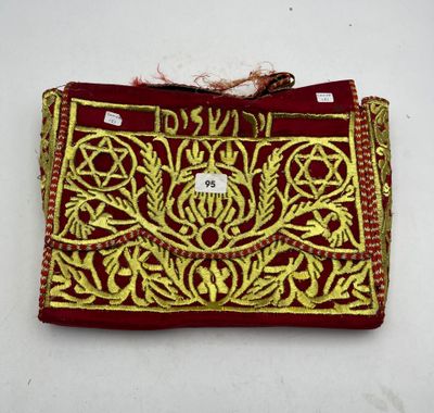 an image of a red and gold embroidered purse with a tag on it