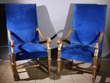 pair of blue velvet upholstered chairs in a room