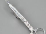 a pair of scissors sitting on a gray surface