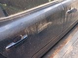 a black car parked on the side of the street