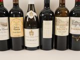 several bottles of wine are lined up on a table