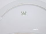 a close up of a white plate with a green label on it