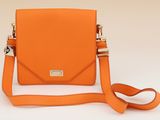 an orange cross body bag with a strap on a white background