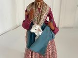 figurine of a woman holding a lamb in her hands