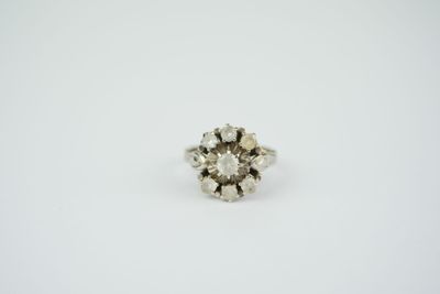 an old cut diamond ring on a white background