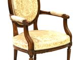 an image of a wooden chair with a beige upholstered seat