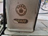 a close up of an old sewing machine with a logo on it