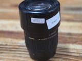 a close up of a camera lens sitting on a wooden table