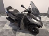a motor scooter that is parked on a checkered floor