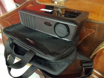a radio sitting on top of a bag on a table