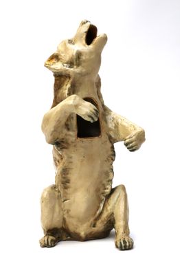 a small statue of a bear sitting on its hind legs