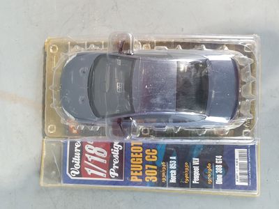a toy car in a plastic package on a table