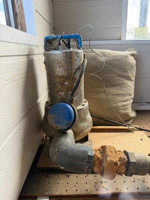 a pipe that is sitting on the floor next to a pillow
